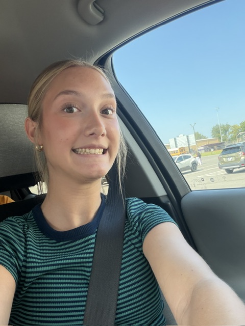 Student buckled in for a seat belt selfie