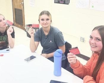 Students hold Graduated Driver License info cards