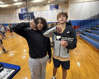 Students give a thumbs down to texting and driving in a gym