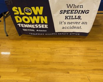 Slow Down Tennessee and When Speeding Kills banners on a table