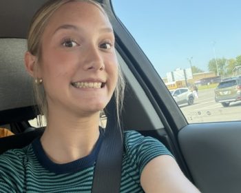 Student buckled in for a seat belt selfie