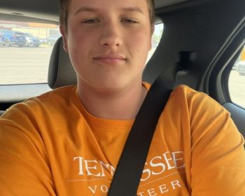 Student buckled in for a seat belt selfie