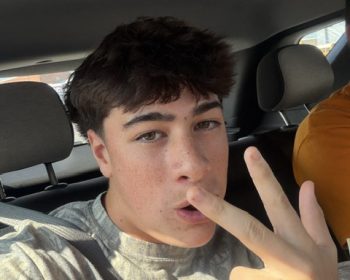 Student buckled in for a seat belt selfie