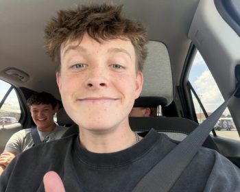 Student buckled in for a seat belt selfie