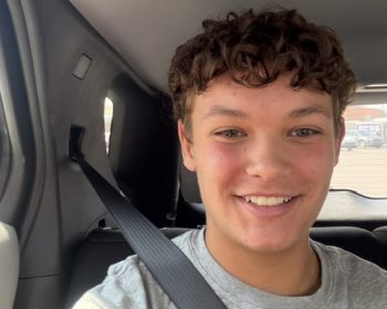 Student buckled in for a seat belt selfie