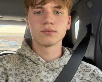 Student buckled in for a seat belt selfie